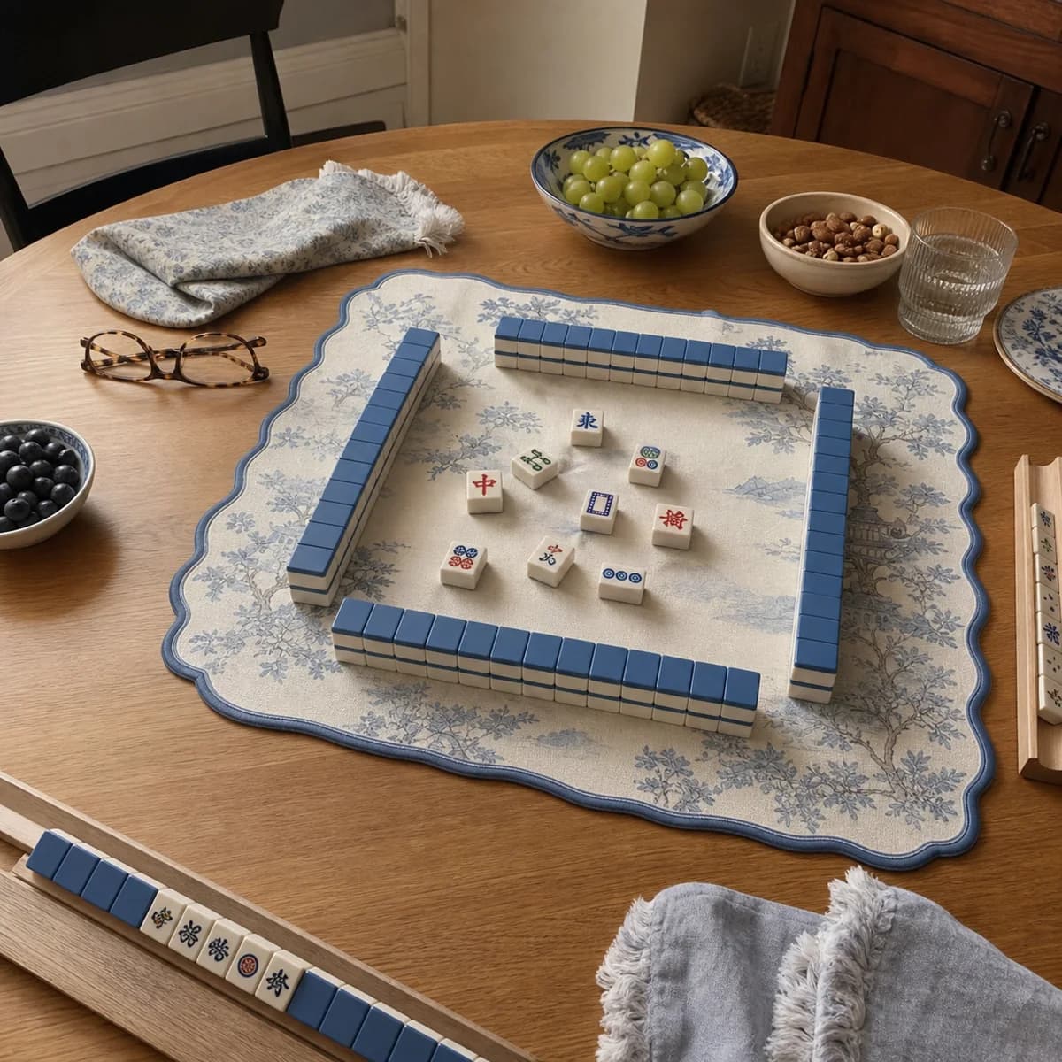 Blue botanical Mahjong mat styled on a casual home table